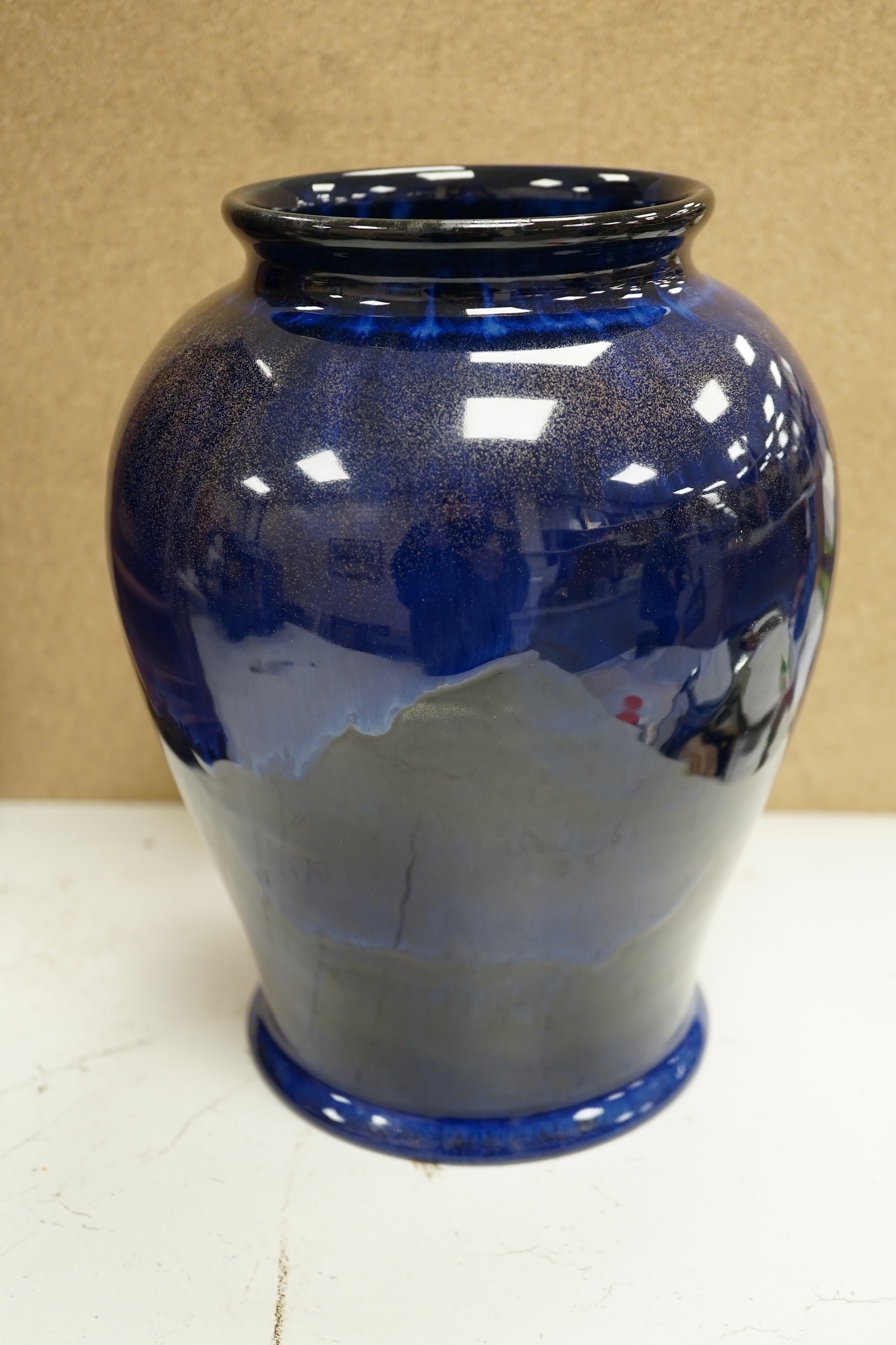 An experimental Doulton Lambeth blue glazed with gilt spray vase, 24cm. Condition - good